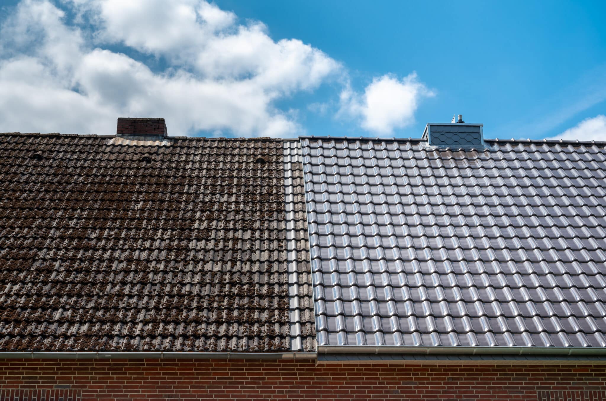 A half cleaned house roof shows the before and after effect of a